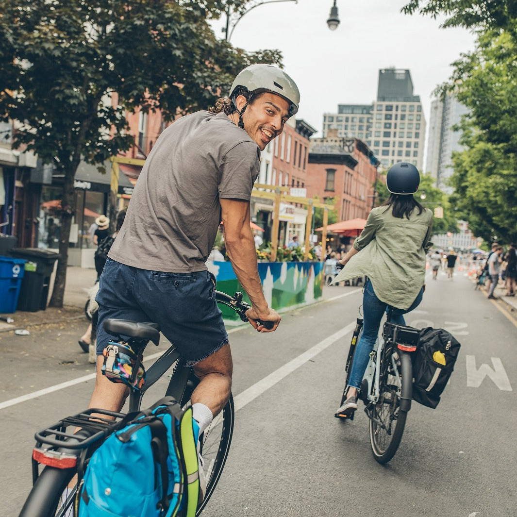 Two people riding bikes with Mardy Backpack Panniers